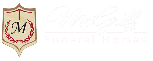 Gold shield logo with red laurel wreath and black “M” over faint “McNulty Funeral Homes” text