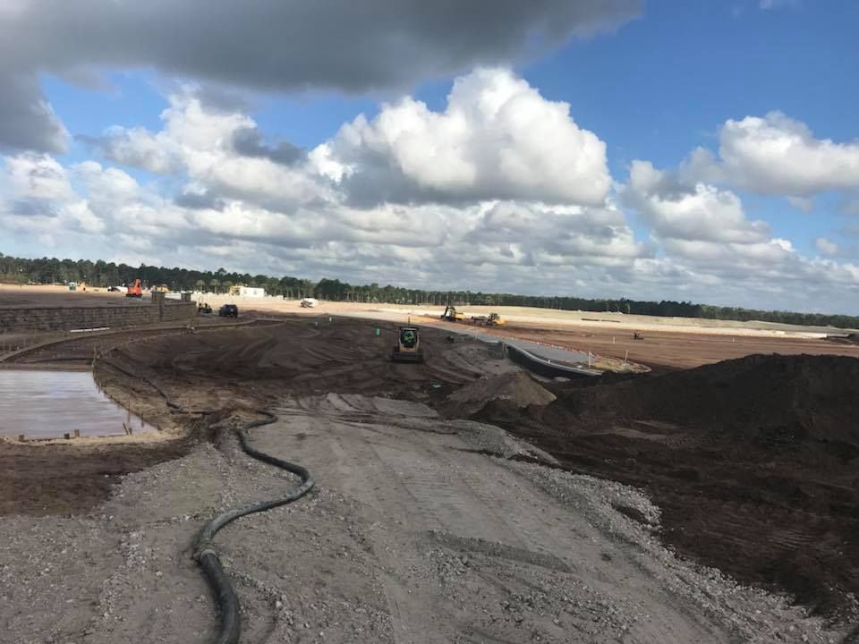A large pile of dirt is sitting on top of a dirt field.