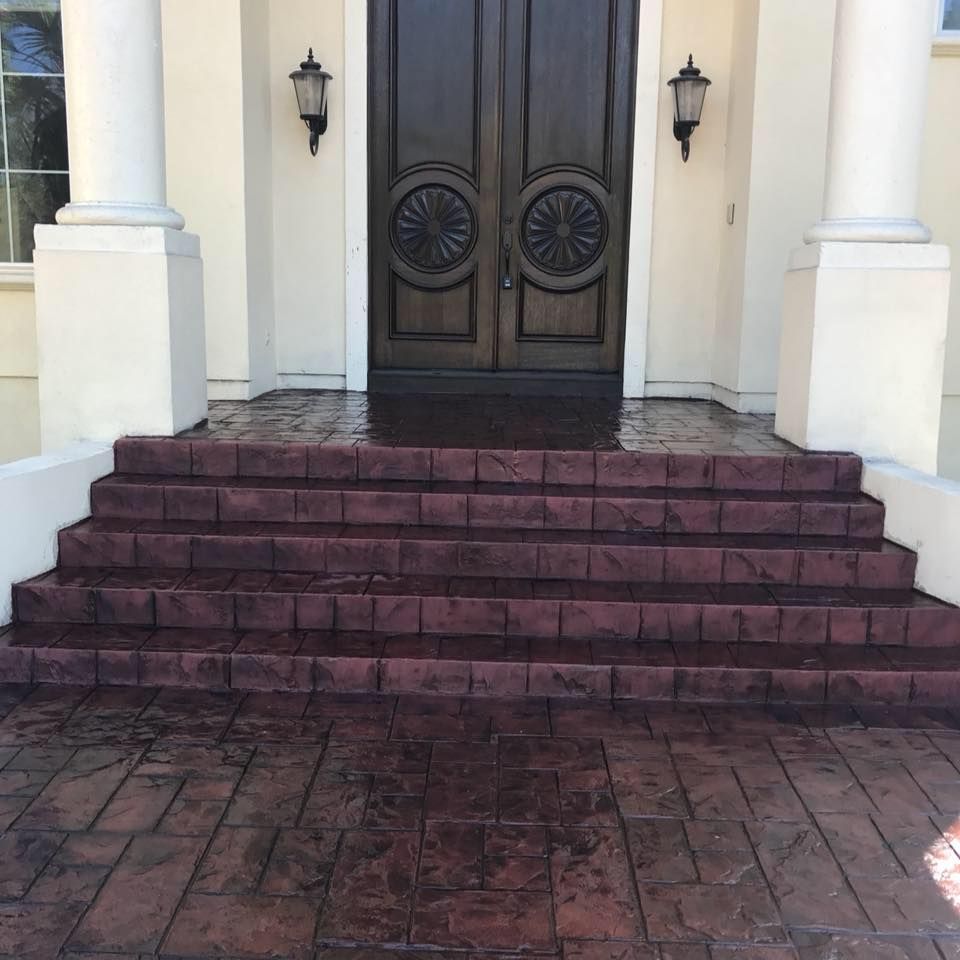 A set of stairs leading up to a door of a house