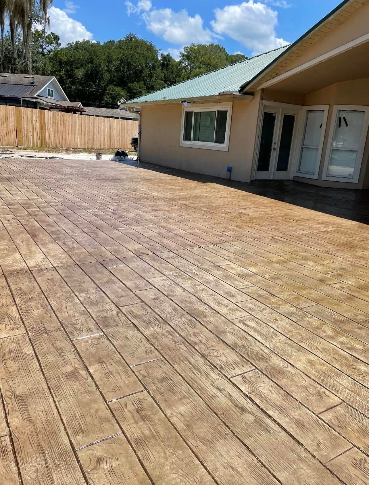 A house with a wooden deck in front of it.