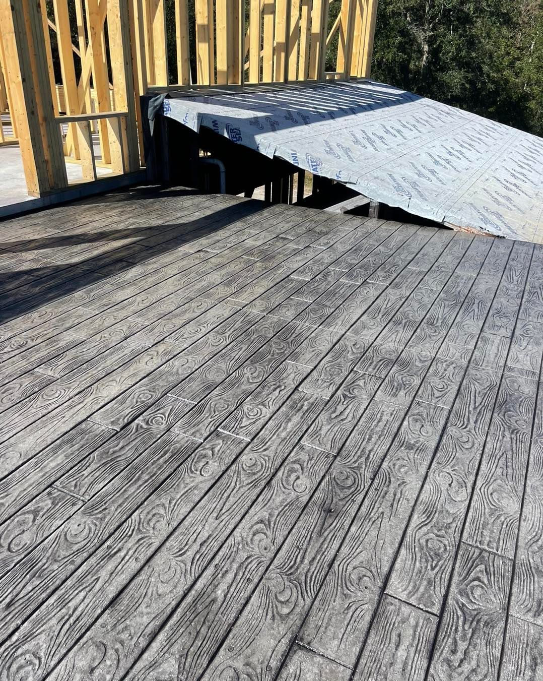 A wooden deck with a ramp in the background.