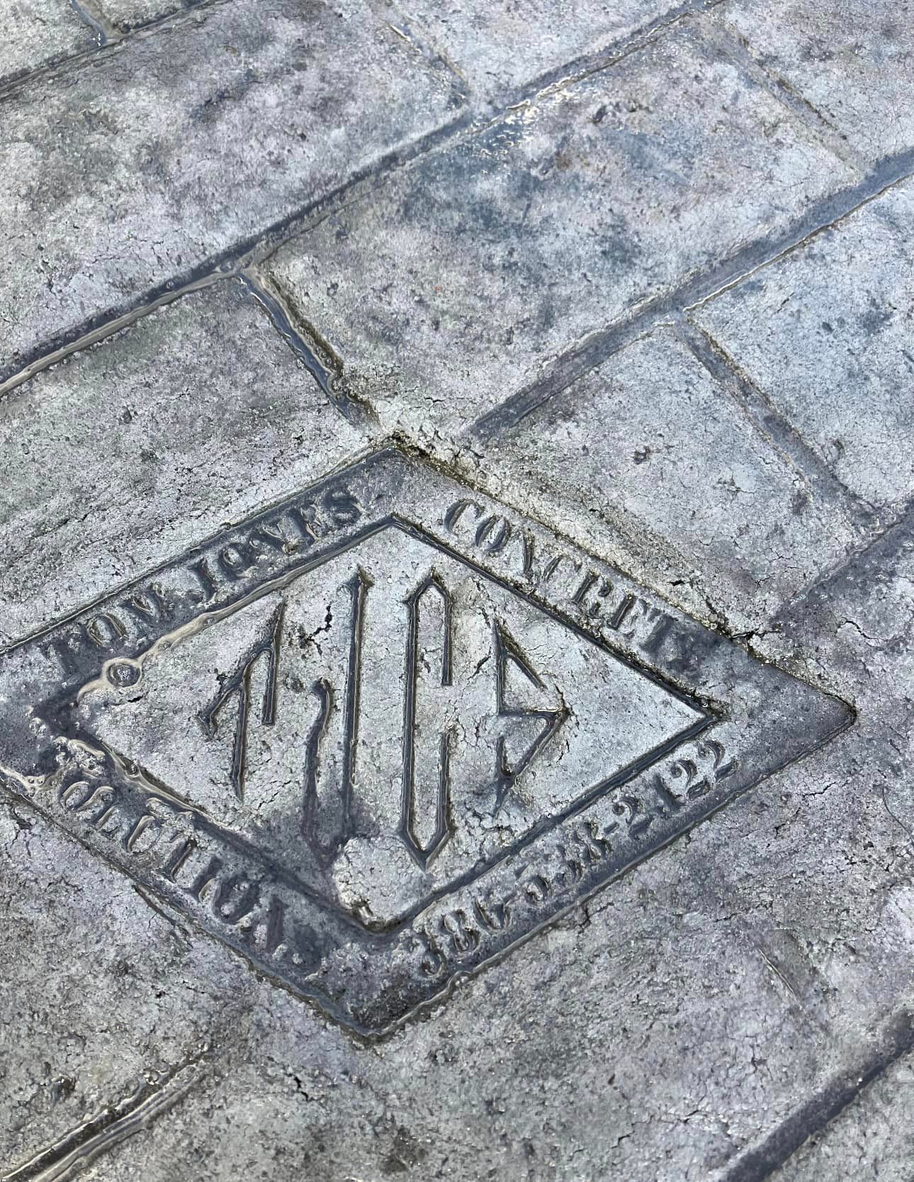 A close up of a concrete floor with a logo on it.
