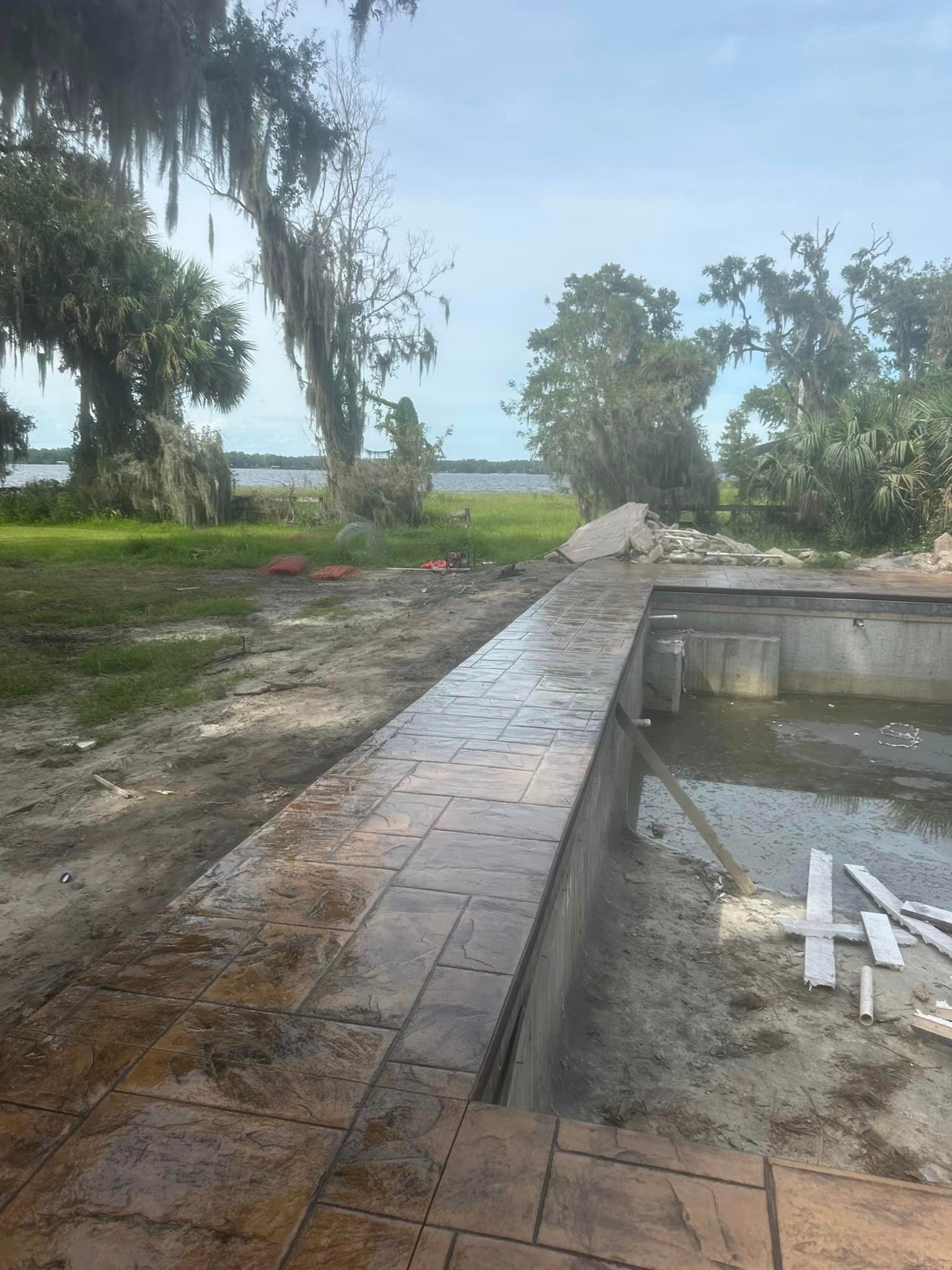 A swimming pool is being built on the shore of a lake.