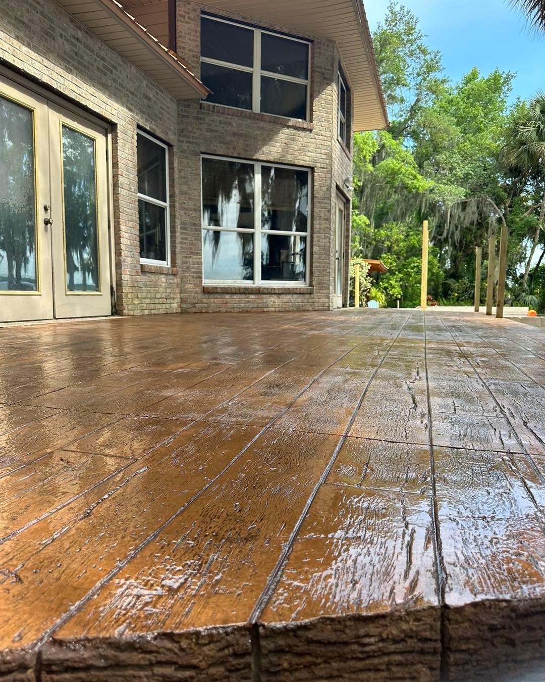 A brick house with a wooden deck in front of it.