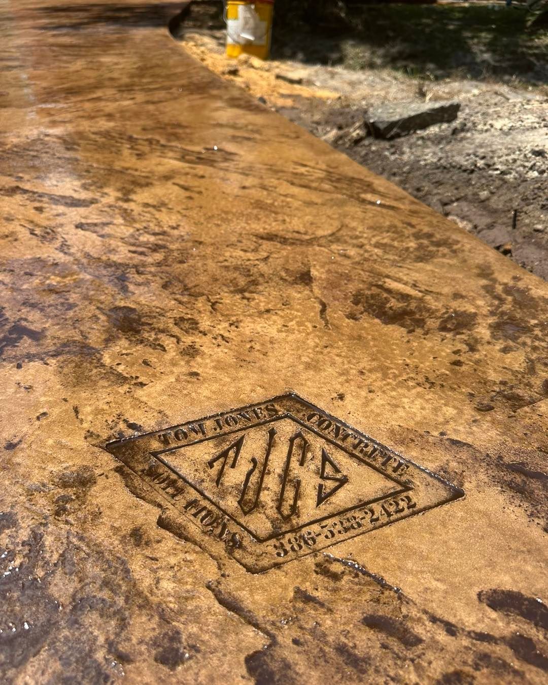 A close up of a concrete surface with a logo on it.