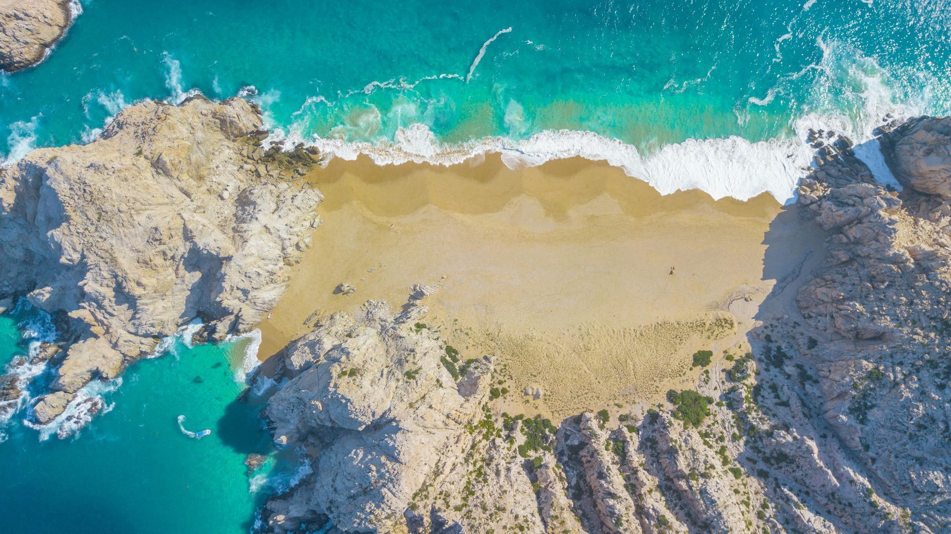 Mar turquesa alrededor de islas rocosas con un texto de cita inspiradora blanca centrado sobre el agua.