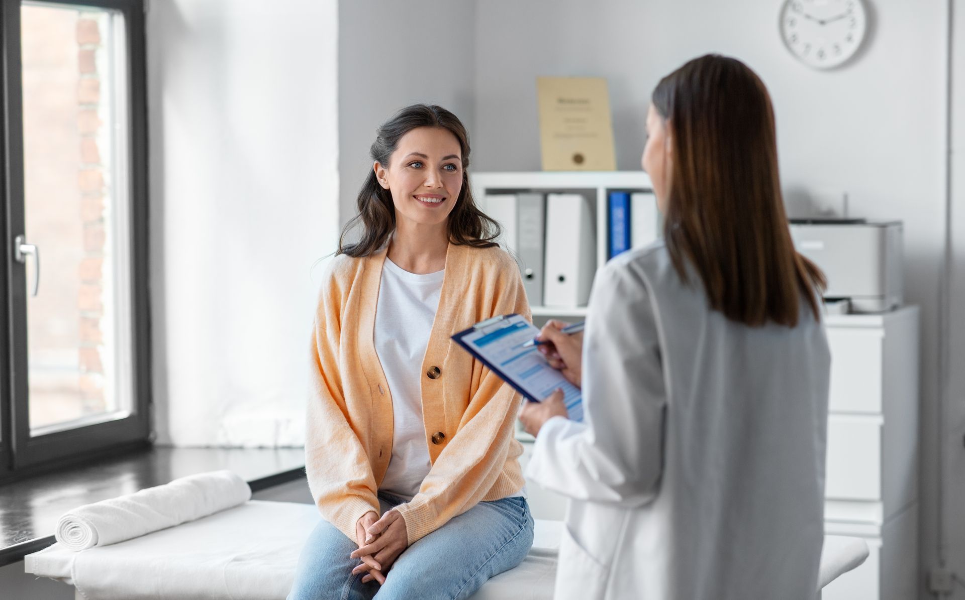 Doctor discussing female health services coverage with a patient.