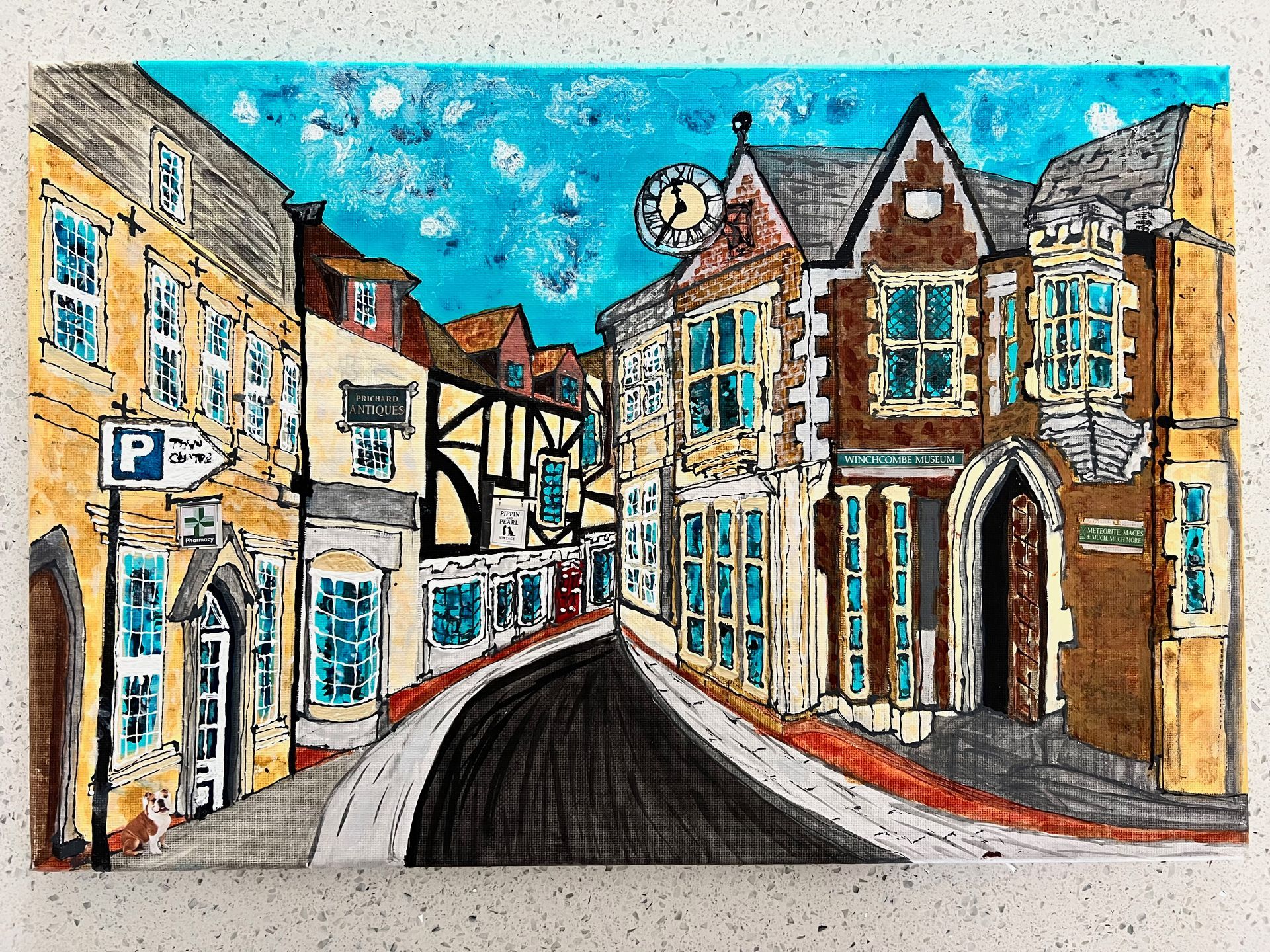 A colorful drawing of a European street with buildings, a clock tower, and a curving road under a blue sky.