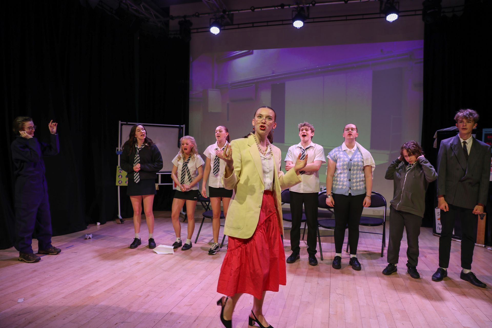 A group of people are standing on a stage.