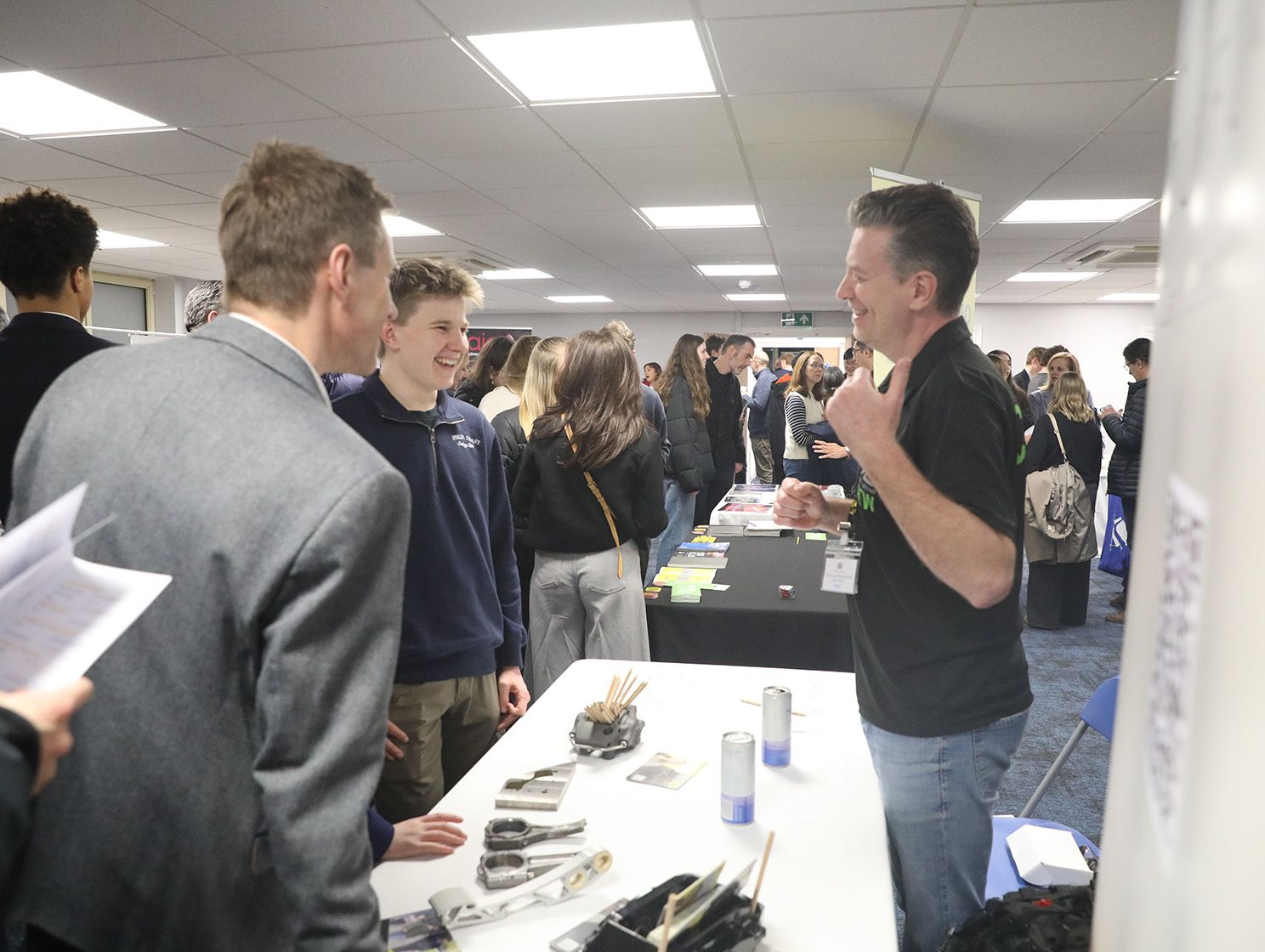 A man is talking to a group of people in a room.