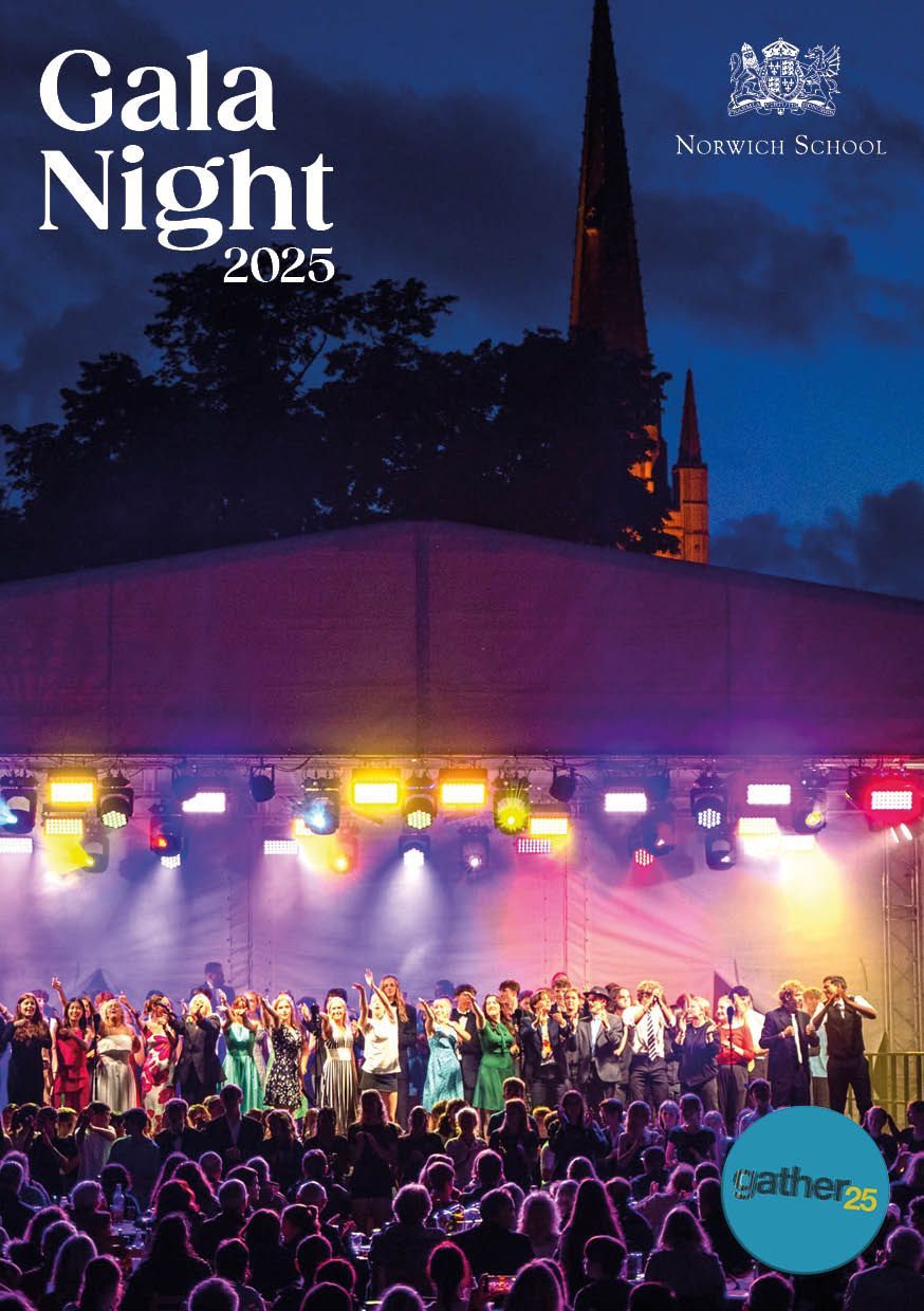 A group of people are standing on a stage at a gala night
