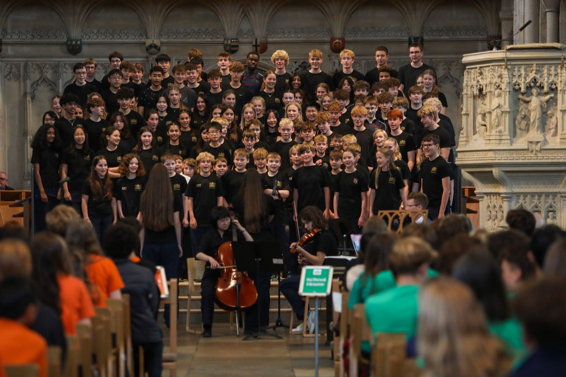 A large group of people are singing in a church