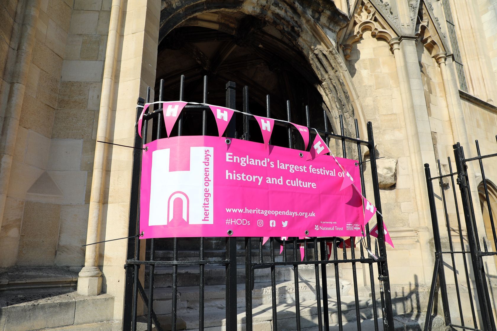A pink banner with the letter h on it