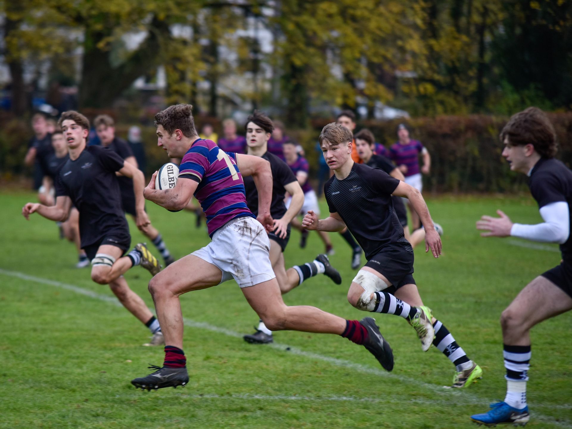 A group of rugby players are huddled together on the field.