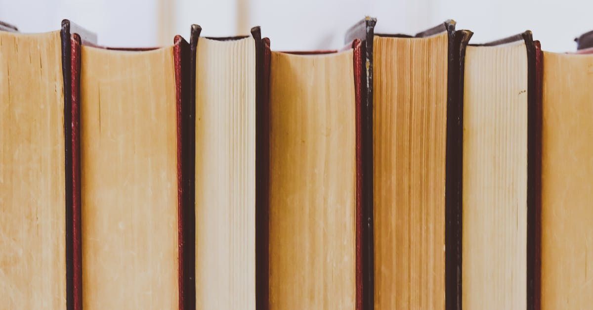 A row of books stacked on top of each other on a table.