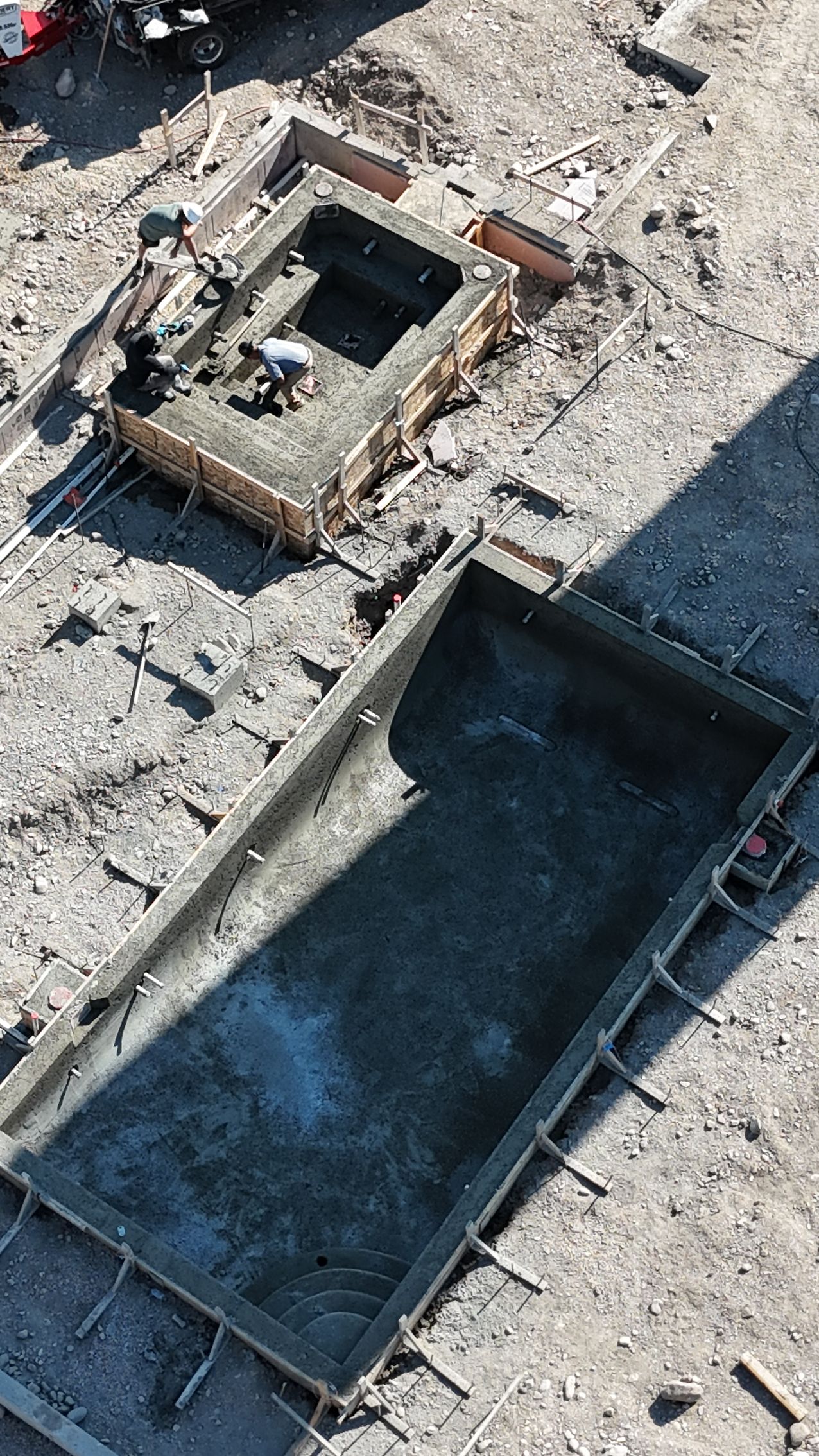 Aerial view of a damaged rooftop with a rectangular hole and debris scattered across the surface