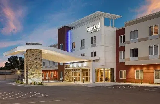 Holiday Inn hotel entrance at dusk with modern facade and covered driveway