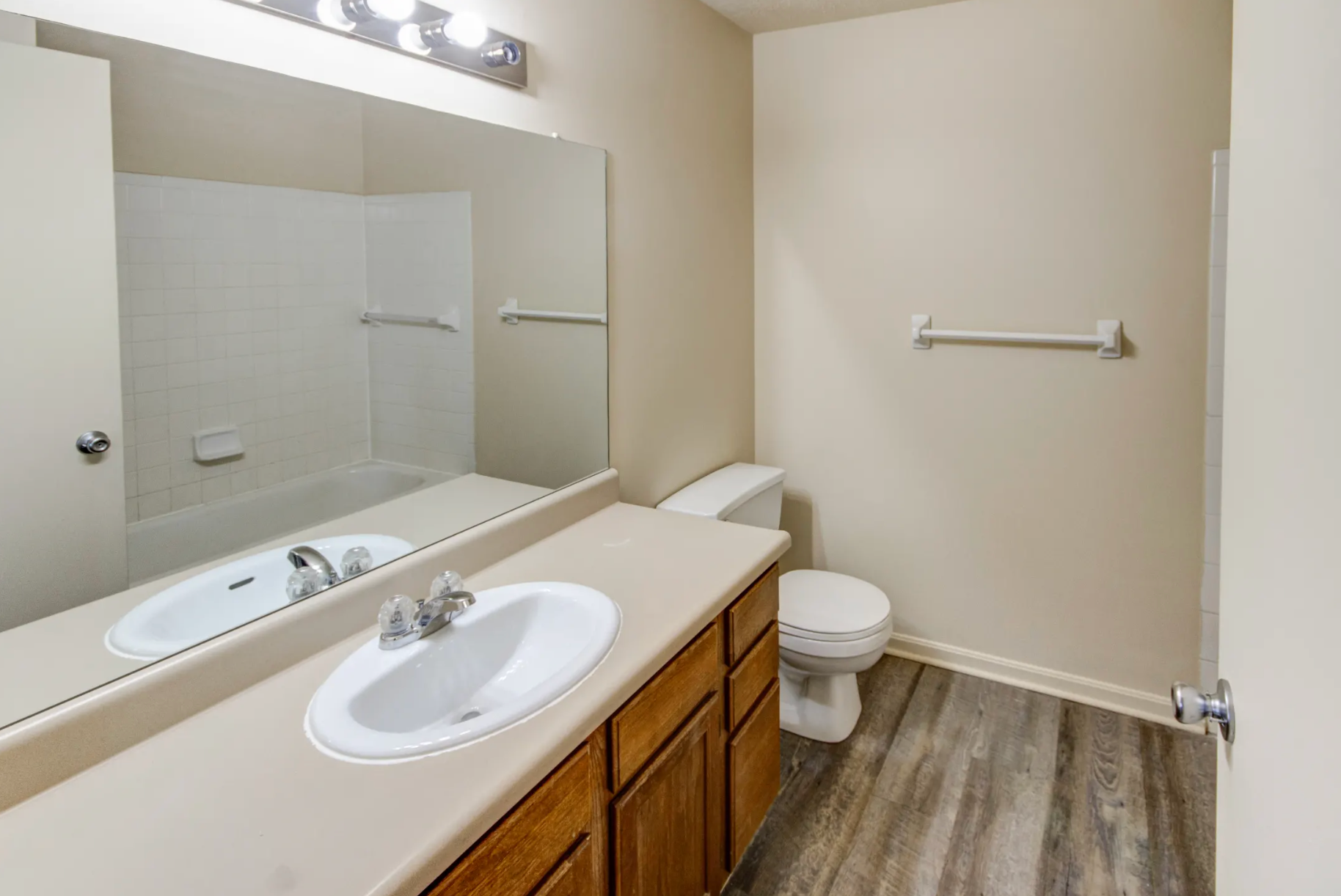 A bathroom with a sink , toilet , and mirror.