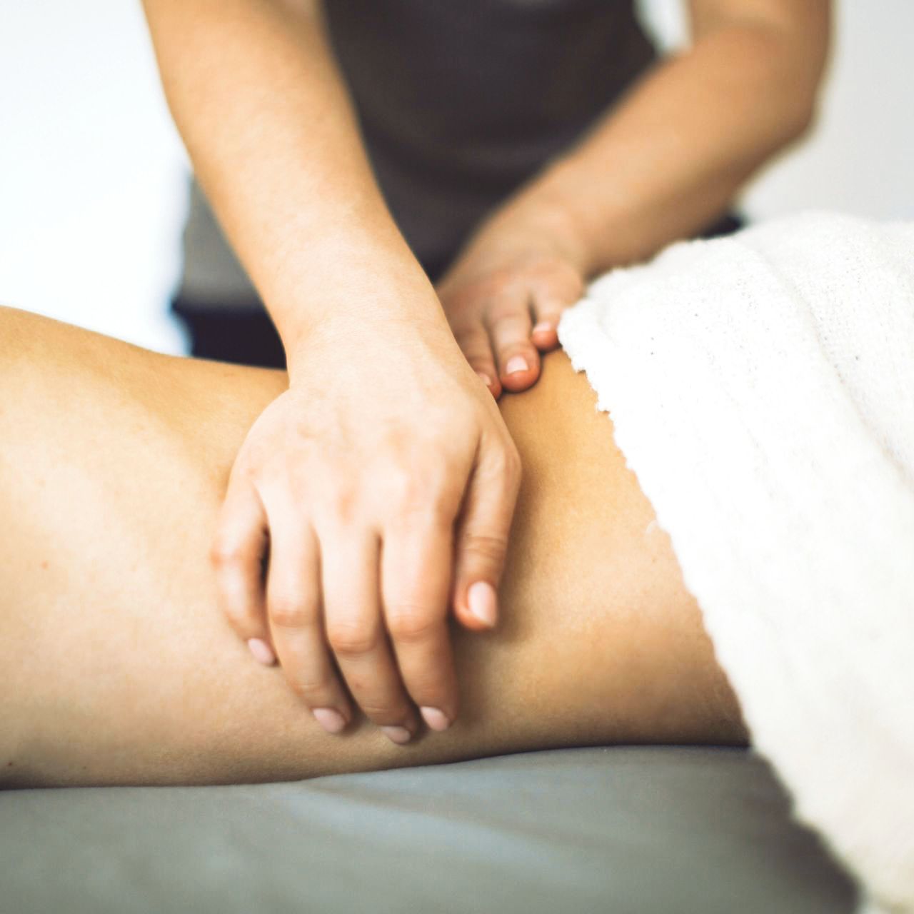 A woman is getting a massage on her back