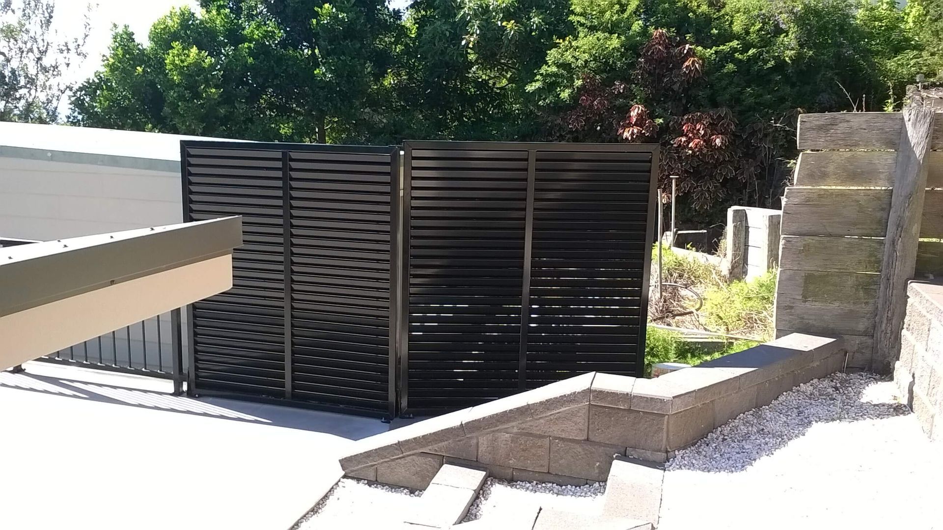 Outdoor Courtyard with Black Slatted Screen — Weldcro Fabrication in Ballina, NSW