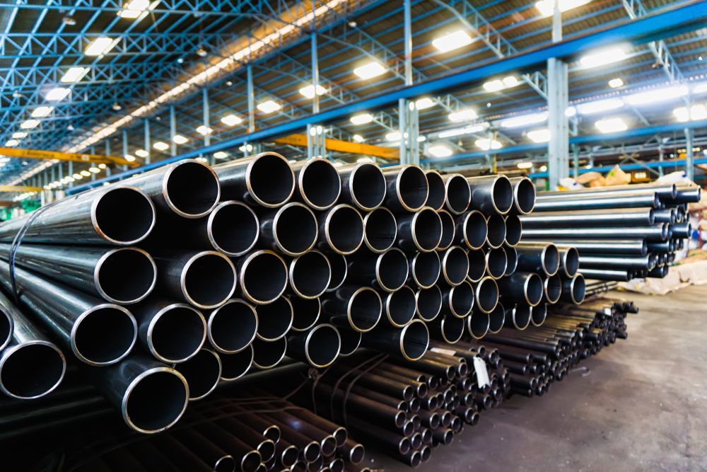 Black Metal Pipes In Warehouse — Weldcro Fabrication in Ballina, NSW