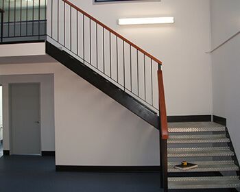 Indoor Metal Stairwell with Wooden Railing — Weldcro Fabrication in Ballina, NSW