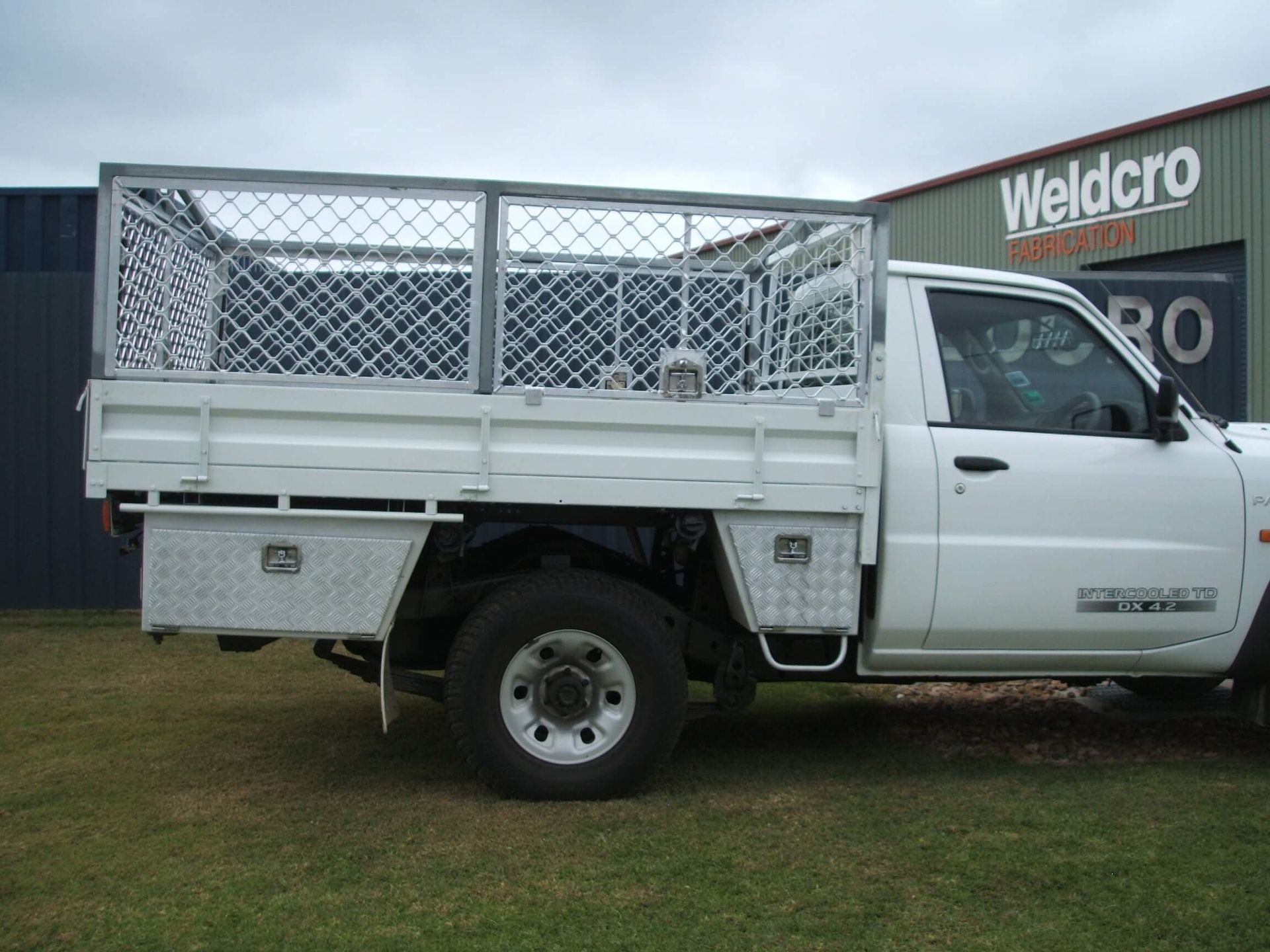 White Ute Truck with Mesh Canopy Parked on Grass — Weldcro Fabrication in Ballina, NSW