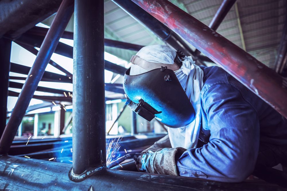 Welder Welding Metal Beams Indoors — Weldcro Fabrication in Ballina, NSW
