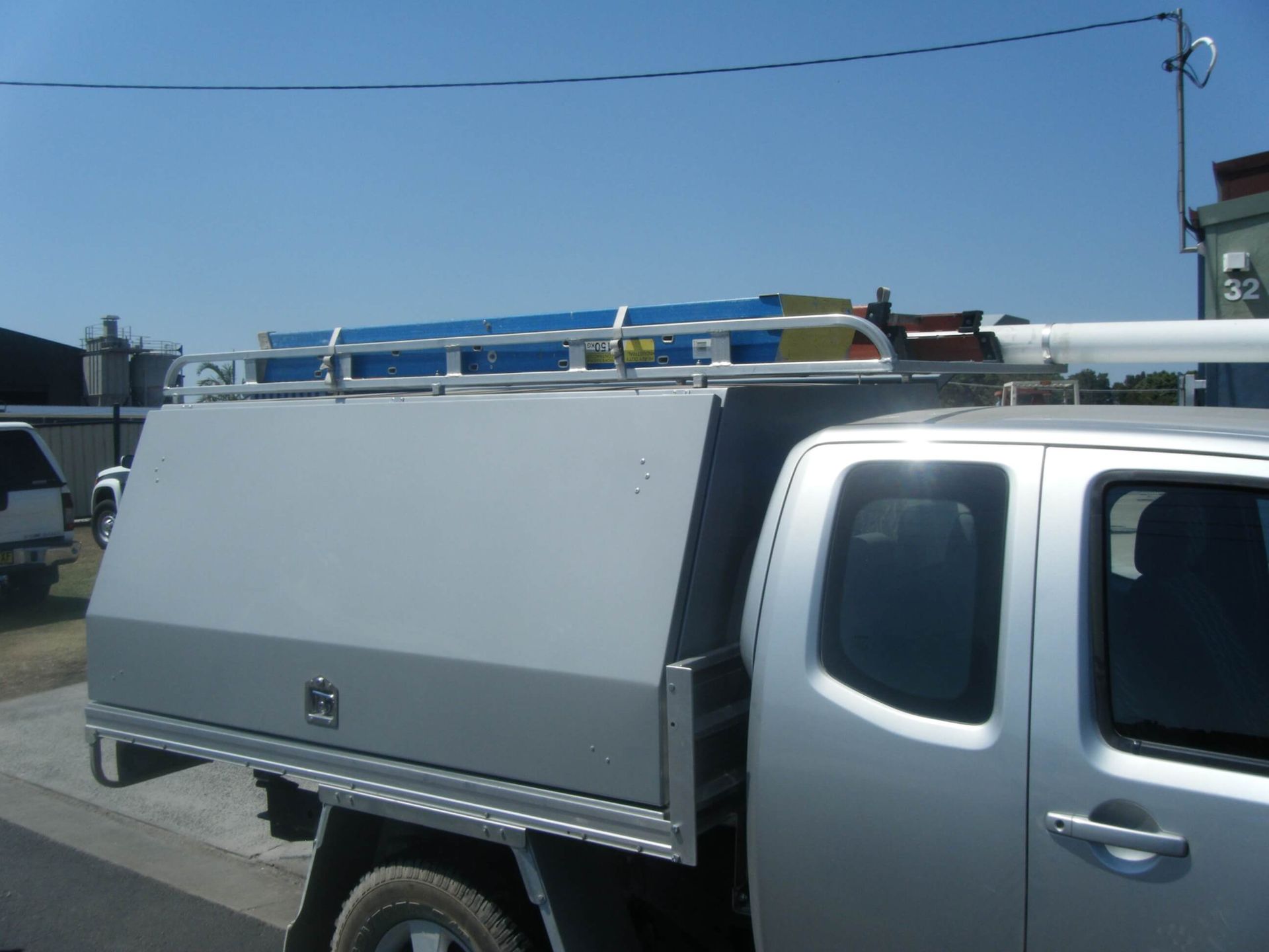 Silver Utility Truck with A Steel Door Covered Cargo — Weldcro Fabrication in Ballina, NSW