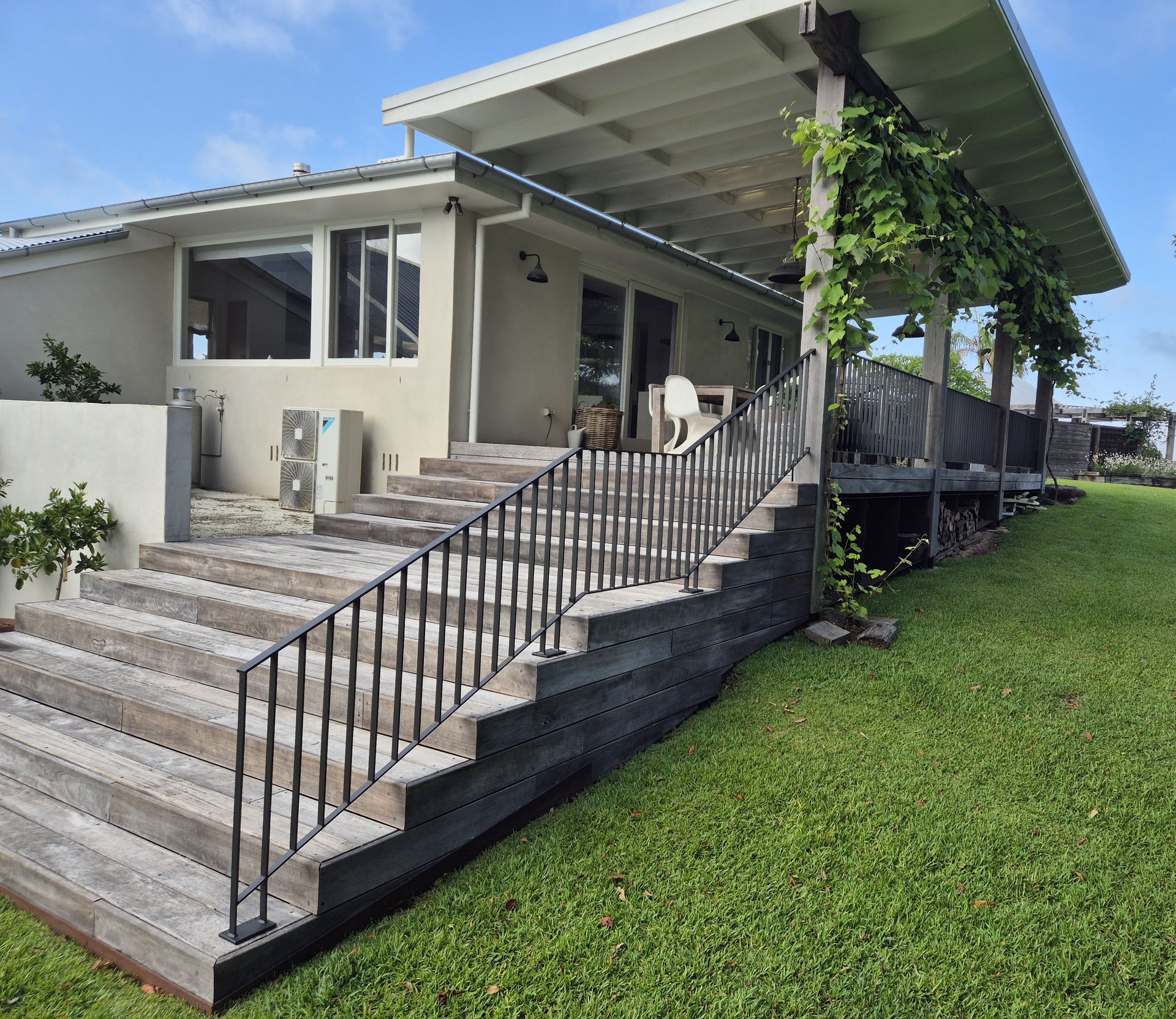Modern House Exterior with Wide Steps, Metal Railing, and a Patio — Weldcro Fabrication in Ballina, NSW