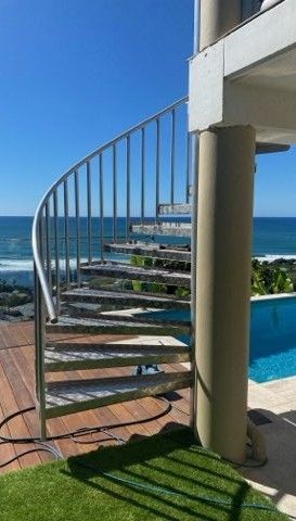 Curved Metal Spiral Staircase by A Pool — Weldcro Fabrication in Ballina, NSW