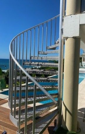 Curved Metal Outdoor Spiral Staircase — Weldcro Fabrication in Ballina, NSW