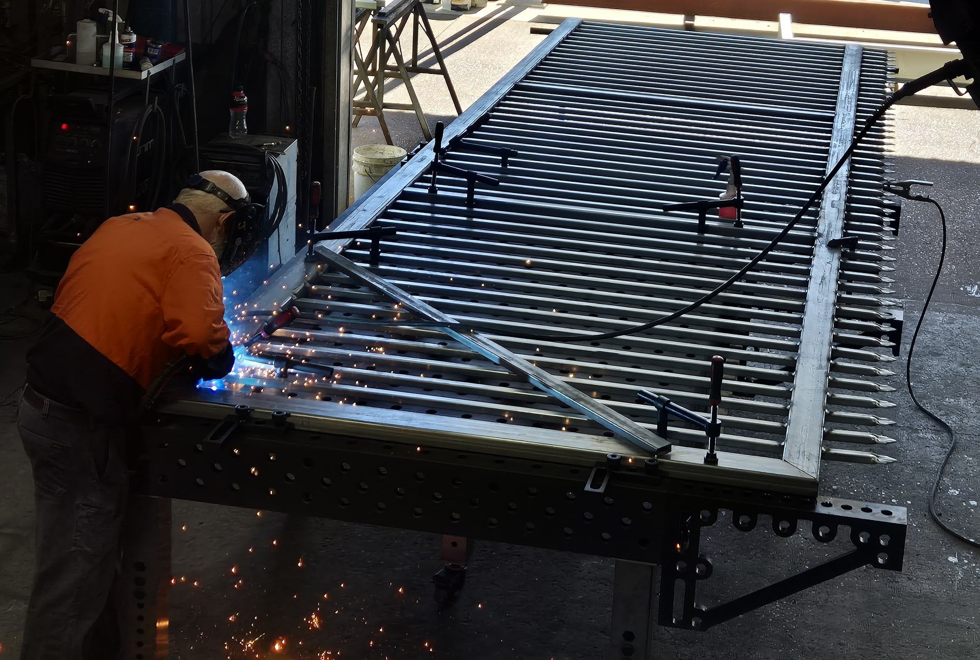 Welder Welding Metal Frame Outdoors — Weldcro Fabrication in Ballina, NSW