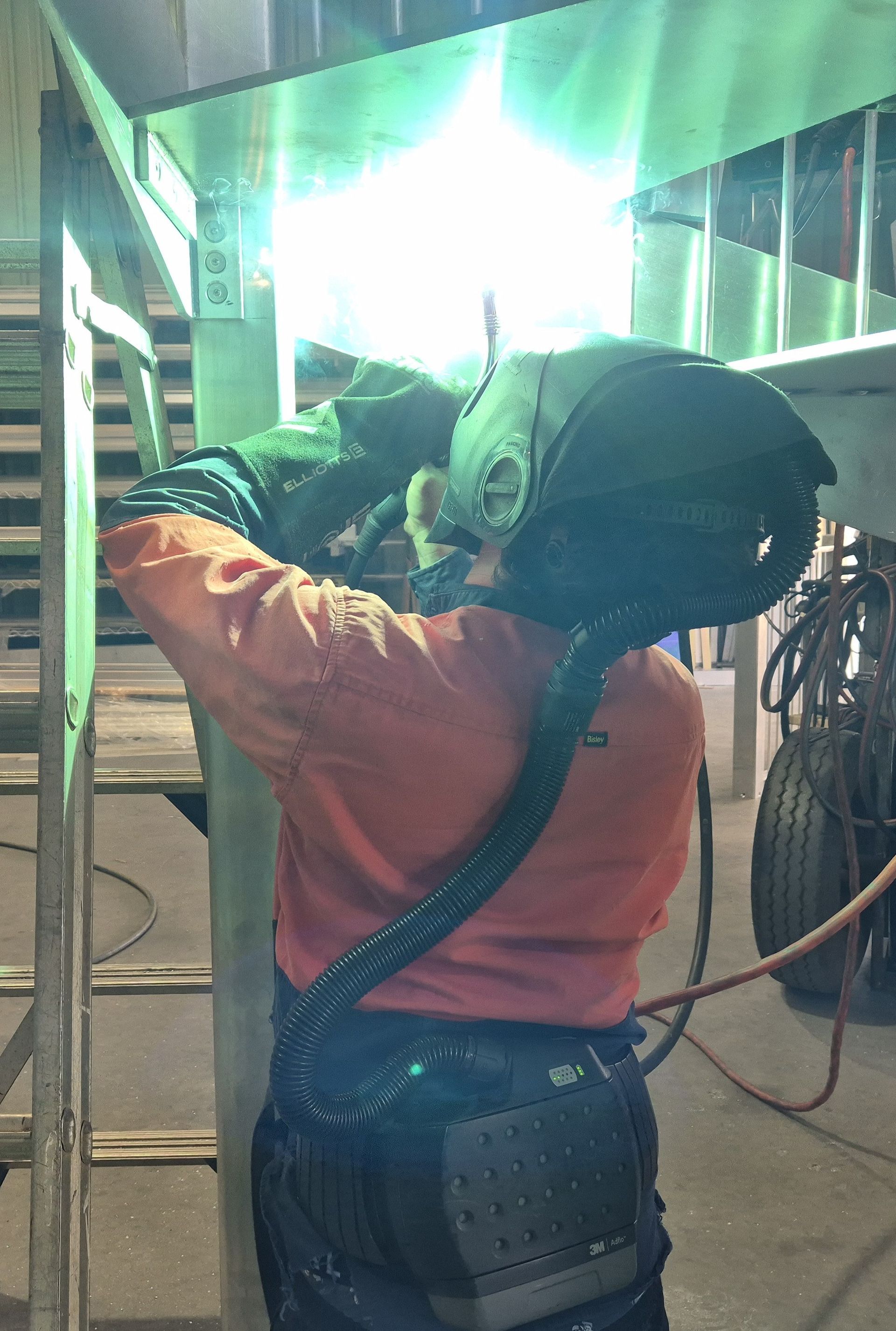 Welder In Yellow And Blue Shirt — Weldcro Fabrication in Ballina, NSW