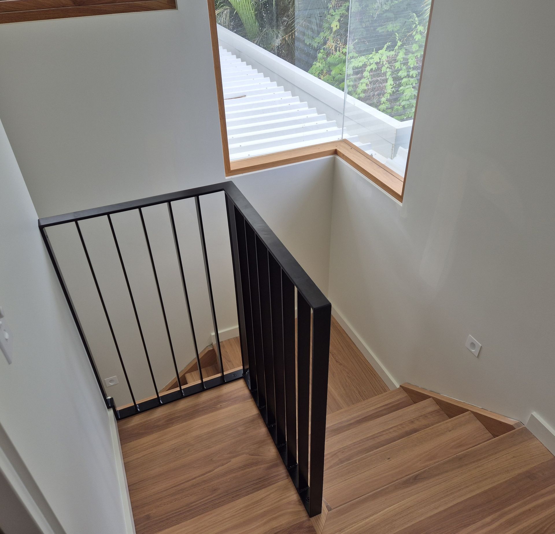 Stair Landing with Black Metal Railing — Weldcro Fabrication in Ballina, NSW
