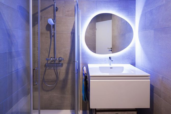 A Bathroom with A Light-up Mirror, Sink, and Shower — Affordable Tiling & Waterproofing in Kirwan, QLD