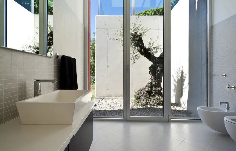 A Bathroom with A Glass Window and A Walk in Shower — Affordable Tiling & Waterproofing in Kirwan, QLD