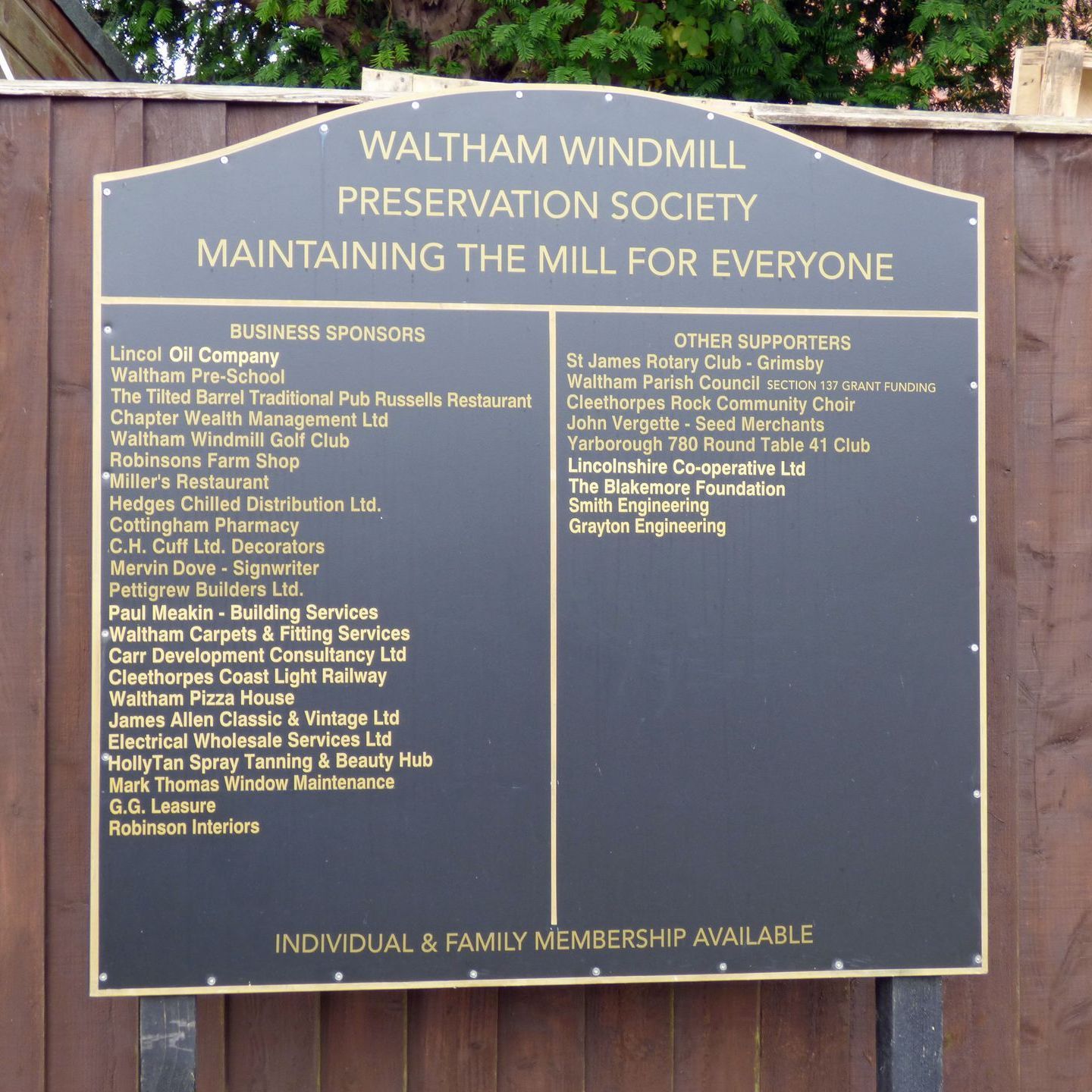 A sign that says waltham windmill preservation society maintaining the mill for everyone