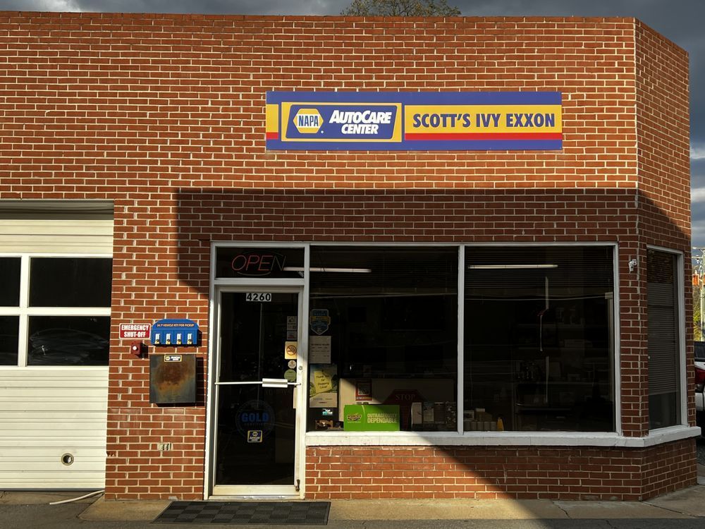 Brick store with blue-and-yellow sign and glass storefront | Scott's Ivy Exxon Automotive & Tire