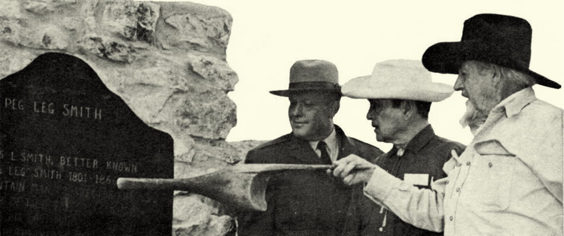 Harry Oliver pointing a Peg leg at the Pegleg Smith Historic Marker in Borrego Springs 