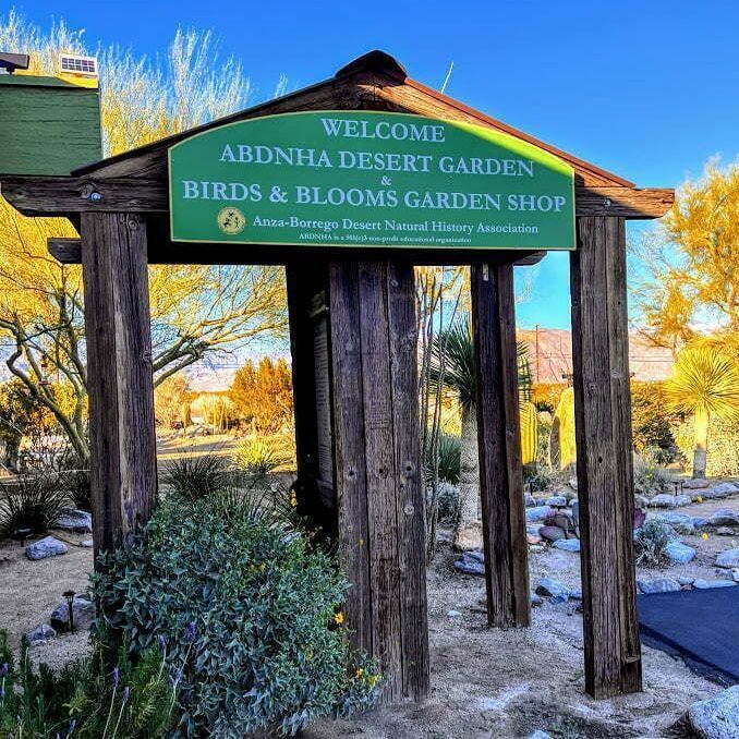Welcome sign at Abingdon Desert Garden and Birds & Blooms Garden Shop on a sunny day