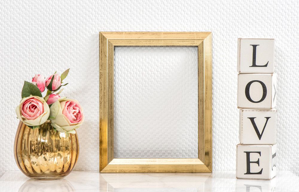 A Picture Frame Is Sitting on A Table Next to A Vase of Flowers — The Framer In Forster, NSW