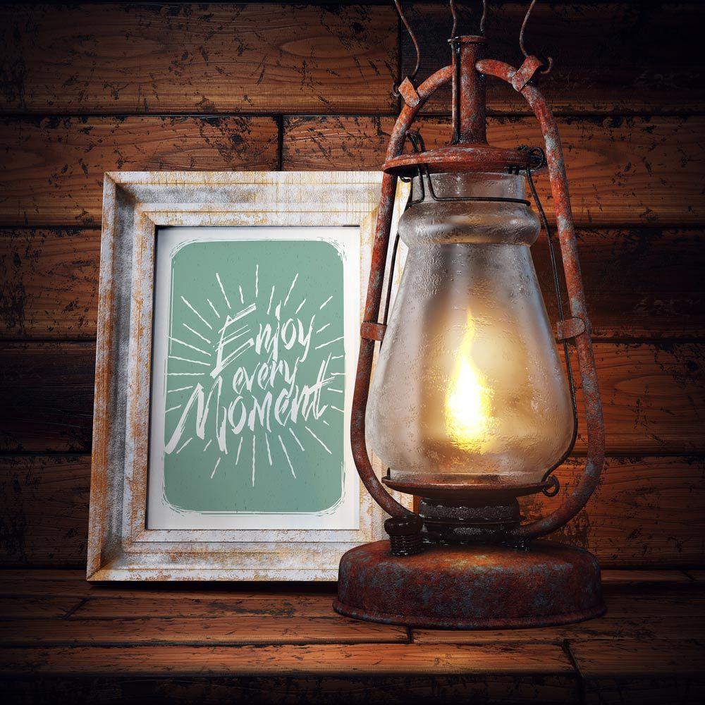 A Lantern Is Lit up Next to A Framed Picture that Says Enjoy Every Moment — The Framer In Nabiac, NSW