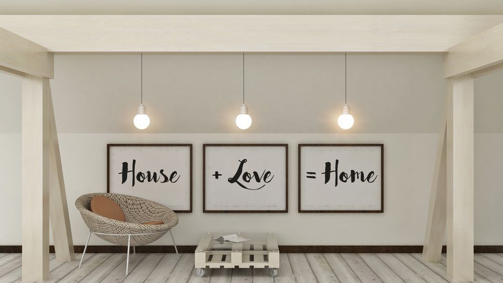 A Living Room with Three Framed Pictures on The Wall that Say House Love Home — The Framer In Taree, NSW