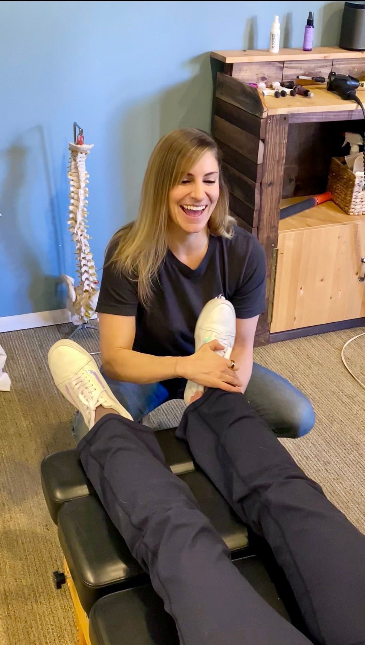 Physical therapist working with a patient on a massage table in a clinic room