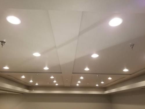 Empty conference room ceiling with recessed lights and neutral beige walls
