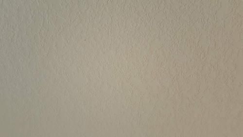 Close-up of a beige textured wall.