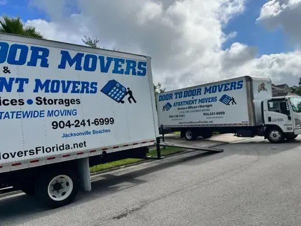 Movers loading furniture into a truck while a couple watches. Movers loading furniture into a truck while a couple watches.