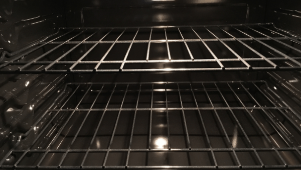 A clean oven inside. Showing the eracks of an oven gleaming. Oven Cleaning Bexhill.
