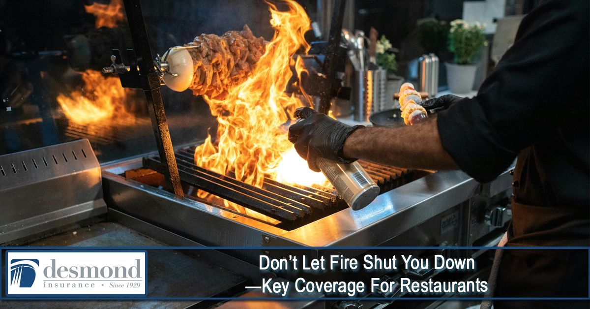 Chef grilling with flames, hands in gloves, restaurant kitchen.